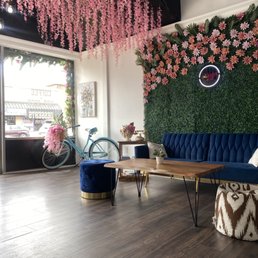 a blue velvet couch and a wooden coffee table a blue velvet couch and a wooden coffee table