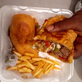 Sabro Tacos - a person holding a sandwich and french fries - Tacos Near Me - Arlington, Texas