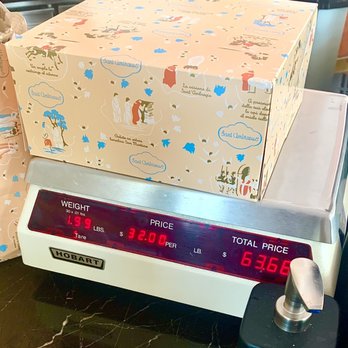 Sant Ambroeus Southampton - Weighing the box of cookies (minus weight of the box) - Italian Near Me - Southampton, New York Sant Ambroeus Southampton - Weighing the box of cookies (minus weight of the box) - Italian Near Me - Southampton, New York