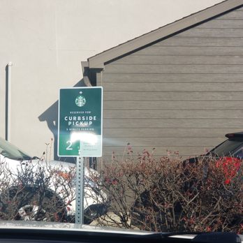 Starbucks - a street sign in front of a building - Coffee & Tea Near Me - Orland Park, Illinois
