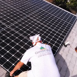 Green City Solar - Robert Olan owner of Green City Solar installing solar electric panels.