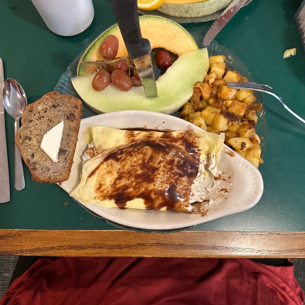Chocolate banana Crepe, home fries, fresh fruit, and banana bread slice Chocolate banana Crepe, home fries, fresh fruit, and banana bread slice
