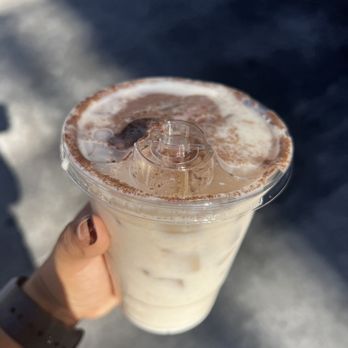Andante Coffee Roasters - a hand holding a cup of coffee - Coffee & Tea Near Me - Los Angeles, California