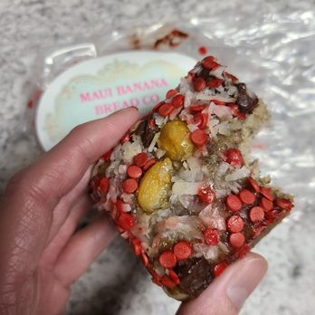 Maui Banana Bread  - a hand holding a piece of cake - Bakeries Near Me - Lahaina, Hawaii