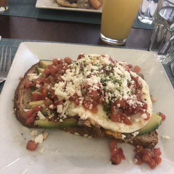 Brunch - Avocado toast with two fried eggs....Bro-mosa in the background - Breakfast & Brunch Near Me - Milwaukee, Wisconsin