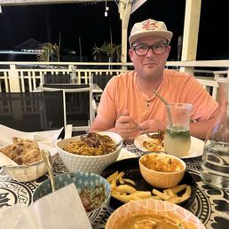 Roti, Chicken Biryani. Fries with Butter Chicken, with the Chilli Chicken in the blue bowl. Garlic Naan Chicken Tikka Masala Roti, Chicken Biryani. Fries with Butter Chicken, with the Chilli Chicken in the blue bowl. Garlic Naan Chicken Tikka Masala