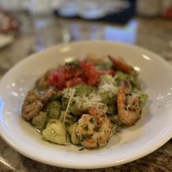 Truffle Stuffed Gnocchi in pesto sauce with added shrimp and chicken in picture.