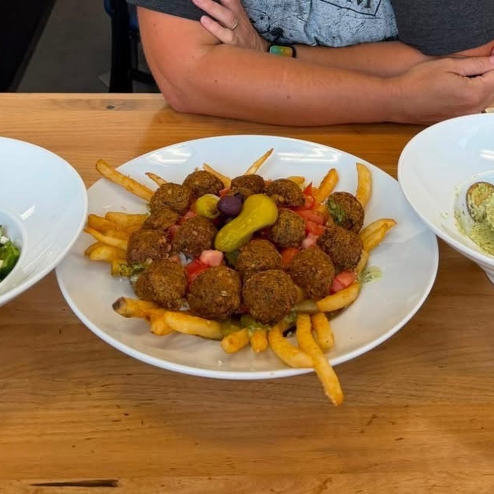 Loaded falafel fries with Greek salad and feta cilantro potatoes