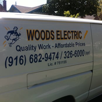 Woods Electric - a van parked in front of a house - Electricians Near Me Woods Electric - a van parked in front of a house - Electricians Near Me