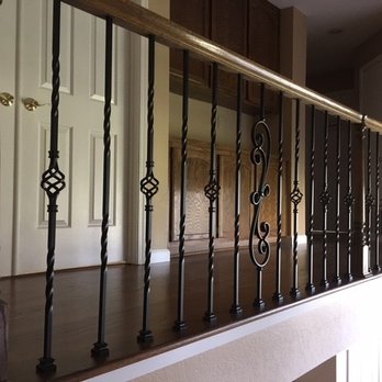 Hardwood Floor Masters - Hallway with hardwood floor and wrought iron spindles to match the staircase - Flooring Near Me Hardwood Floor Masters - Hallway with hardwood floor and wrought iron spindles to match the staircase - Flooring Near Me