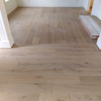 Arias Builders - an empty room with wood floors - General Contractors Near Me