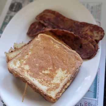 The Forked River Diner - Fresh Toast and bacon. - A breakfast plate featuring French toast and crispy bacon on a white dish, with a glass of water in the background. - American Near Me - Forked River, New Jersey
