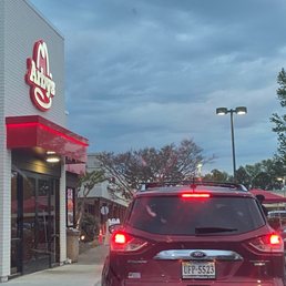 a red car in front of a restaurant