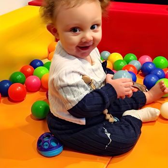Kristilynn's Tiny Teachers - happy baby in the ball pit - Child Care & Day Care Near Me - Rochester, New York