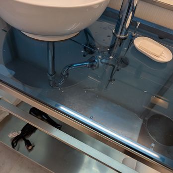 Hotel Murano - Low light bathroom, stained, scratched countertop - Hotels Near Me - Tacoma, Washington
