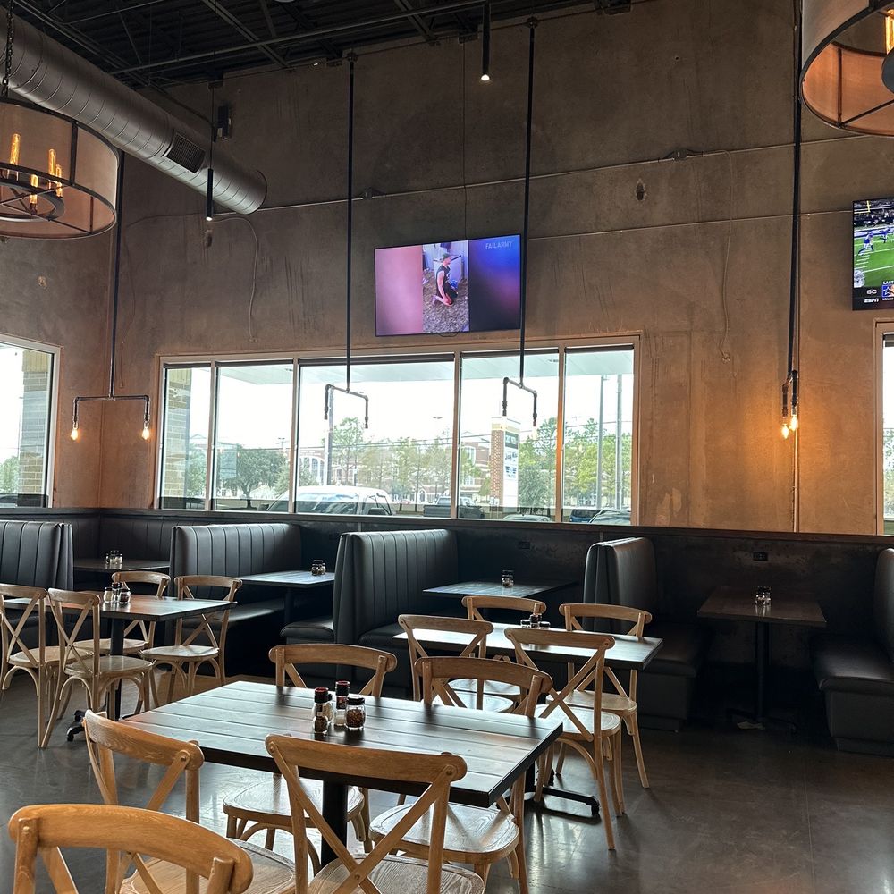 Crust Pizza - Spacious dining room with tvs - Pizza Near Me - Cypress, Texas