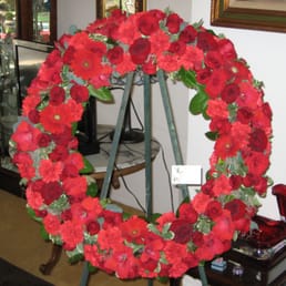 Red rose and other red flower funeral wreath. Red rose and other red flower funeral wreath.
