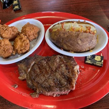 Hitchcock Pub and Grill - Ribeye, baked potato and hush puppies. - Pubs Near Me - Rockingham, North Carolina Hitchcock Pub and Grill - Ribeye, baked potato and hush puppies. - Pubs Near Me - Rockingham, North Carolina