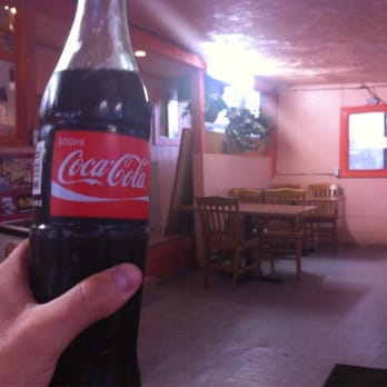 Tacos El Korita - a hand holding a bottle of coca cola - Mexican Near Me - Buhl, Idaho Tacos El Korita - a hand holding a bottle of coca cola - Mexican Near Me - Buhl, Idaho