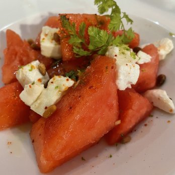 Le Bistro V - WATERMELON SALAD WITH FETA, HONEY, LIME ZESTS, PINE NUTS AND ORANGE BLOSSOM - Bistros Near Me - Paris, 75 Le Bistro V - WATERMELON SALAD WITH FETA, HONEY, LIME ZESTS, PINE NUTS AND ORANGE BLOSSOM - Bistros Near Me - Paris, 75