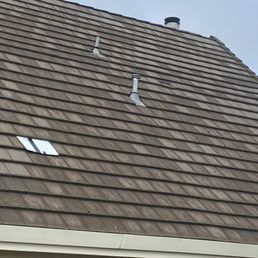 Two tiles replaced on a very steep roof. Two tiles replaced on a very steep roof.