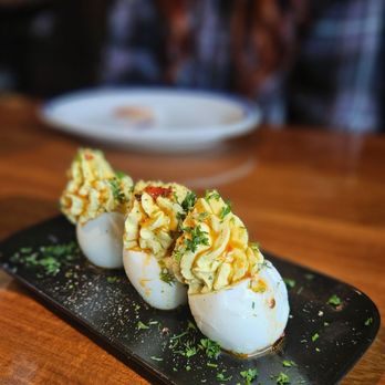 Hudson House - deviled eggs on a black plate - Cocktail Bars Near Me - Houston, Texas Hudson House - deviled eggs on a black plate - Cocktail Bars Near Me - Houston, Texas