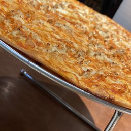 a cheese pizza on a stand a cheese pizza on a stand