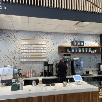 Elixr Coffee - a man standing at the counter - Coffee & Tea Near Me - Philadelphia, Pennsylvania