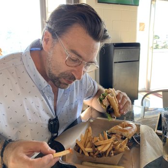 TidePoole's - Gav crushing some fries and the Sandy Hoale (blt with turkey) - Breakfast & Brunch Near Me - Newport Beach, California