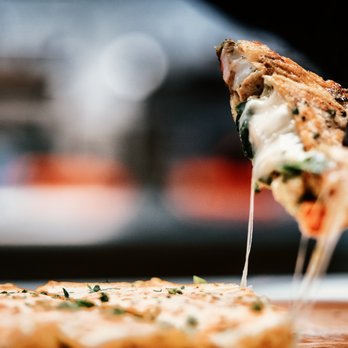 Quesadilla Mia - a person holding a slice of pizza - Food Delivery Services Near Me - Redondo Beach, California Quesadilla Mia - a person holding a slice of pizza - Food Delivery Services Near Me - Redondo Beach, California