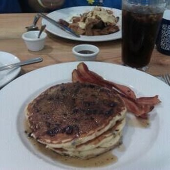 Half & Half - Blueberry pancakes topped w/ blueberry butter and maple syrup.  Side of bacon a la carte. - Breakfast & Brunch Near Me - St. Louis, Missouri