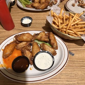 Hilltop Pub and Grill - Wings with sauce and brew city fries - Pubs Near Me - Stevens Point, Wisconsin