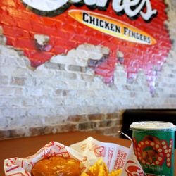 The Sandwich Combo: 3 chicken fingers, Cane's Sauce, lettuce, toasted bun; crinkle-cut fries, 22oz fountain drink / tea ($9.99).