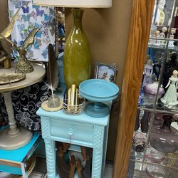 Treasured Again - Telephone table, MCM lamp, brass eagles, and wooden carvings.