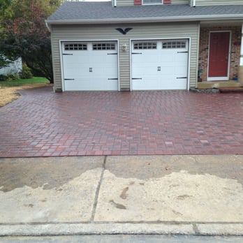 Cambridge Landscapes - a driveway with a brick paver and two garage doors - Landscaping Near Me - Morrisville, Pennsylvania Cambridge Landscapes - a driveway with a brick paver and two garage doors - Landscaping Near Me - Morrisville, Pennsylvania