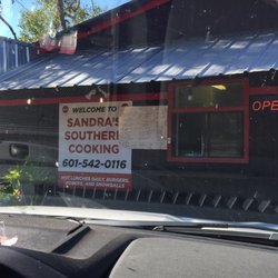 Sandra’s Southern Cooking & BBQ - Outside the restaurant! No inside seating! Small little cabin on a corner lot