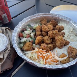 Chicken schnitzel with hummus, baba ghanoush, salad, and cabbage. Garlic mayo and bread on the side.