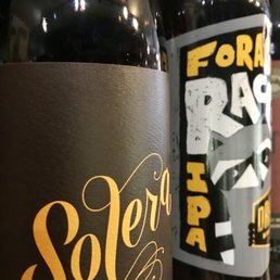 Esoteric craft beers on the shelves for reflective drinking at home.