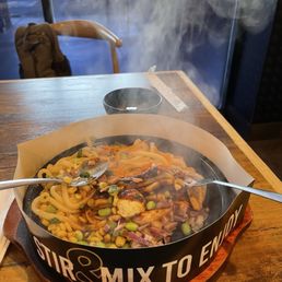 Salmon sizzling plate with udon and house sauce.