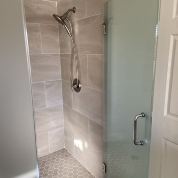 Winpoint Construction - Completed shower with frosted glass door. - General Contractors Near Me