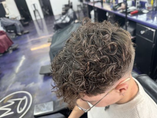 Perm & Shape-Up Combo - A transformation featuring a men’s perm for volume and curls, combined with a clean edge-up. This project shows chemical service skills paired with detailed finishing work. Perm & Shape-Up Combo - A transformation featuring a men’s perm for volume and curls, combined with a clean edge-up. This project shows chemical service skills paired with detailed finishing work.