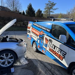 Lube Dudes - Lube Dudes performing a customer's oil change in their apartment's parking lot.