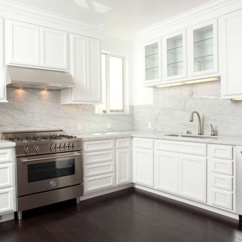 Joe Doerr Construction - a kitchen with white cabinets and stainless steel appliances - General Contractors Near Me - Mill Valley, California Joe Doerr Construction - a kitchen with white cabinets and stainless steel appliances - General Contractors Near Me - Mill Valley, California