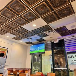 Dasara Indian Cuisine - Sitting area and ceiling decor with TVs dotted throughout