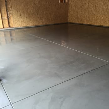 Final Finish Construction - a concrete floor in a garage - Flooring Near Me