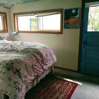 The Painted Hills Vacation Cottages - Bedroom with super comfy bed and a back door to the beautiful garden. - Vacation Rentals Near Me - Mitchell, Oregon The Painted Hills Vacation Cottages - Bedroom with super comfy bed and a back door to the beautiful garden. - Vacation Rentals Near Me - Mitchell, Oregon