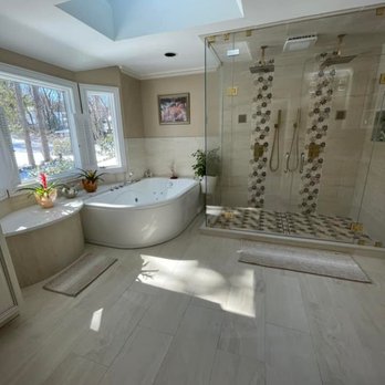 Infinity Construction - a large bathroom with a walk in shower - Roofing Near Me Infinity Construction - a large bathroom with a walk in shower - Roofing Near Me