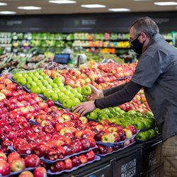 Stop & Shop - Wide shot of associate stocking fresh produce.
