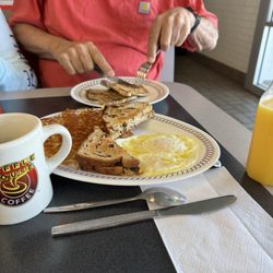 Seasoned pork chop, eggs over easy, raising toast