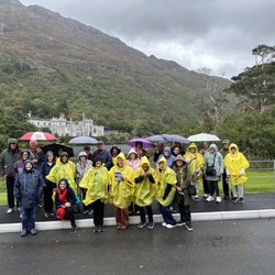 Magnificat Travel - Pilrgimage group standing on the lake facing Kylemore Abbey, 2025 Pilgrimage to Ireland with Fr. Louis Richard